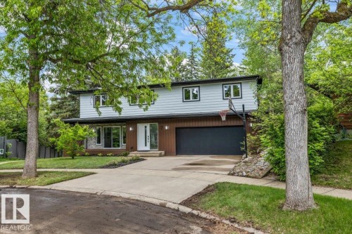 Contemporary-style residence featuring a two-car garage with a dark door - 7 Glacier Place, St. Albert, AB 