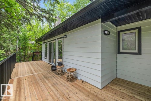 Expansive wood deck with black metal railings, offering an outdoor extension to the residence - 7 Glacier Place, St. Albert, AB 