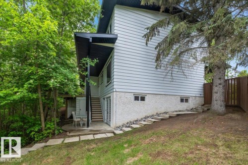 Multi-level exterior with light siding and a dark trim - 7 Glacier Place, St. Albert, AB 