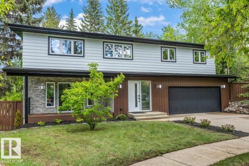 Contemporary two-story residence featuring light gray siding and rich brown paneling - 7 Glacier Place, St. Albert, AB 