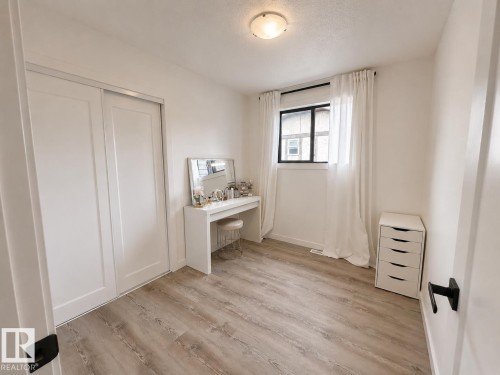 Light-toned wood-finish flooring complements white walls - 38 Woodcrest Avenue, St. Albert, AB 