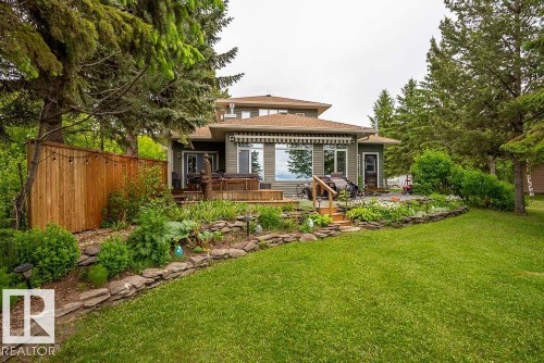 Rear exterior featuring a multi-level deck, large windows, and a retractable awning - A38 Bernice Ave, Rural Leduc County, AB 