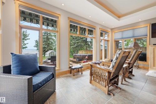 Sunroom with extensive window framing, recessed lighting, tile flooring, and a tray ceiling - A38 Bernice Ave, Rural Leduc County, AB 