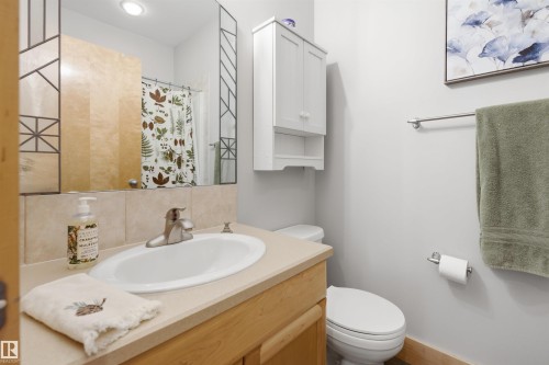 Bathroom featuring a single-sink vanity with a light wood-finish cabinet and a neutral countertop - A38 Bernice Ave, Rural Leduc County, AB 