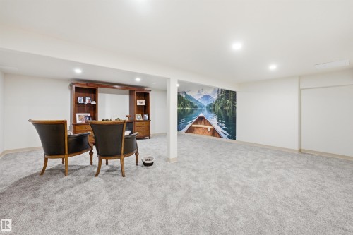 Spacious lower-level room featuring light gray carpet flooring and recessed lighting - A38 Bernice Ave, Rural Leduc County, AB 