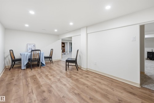 Expansive room featuring wood-finish flooring, recessed lighting, and crisp white walls - A38 Bernice Ave, Rural Leduc County, AB 