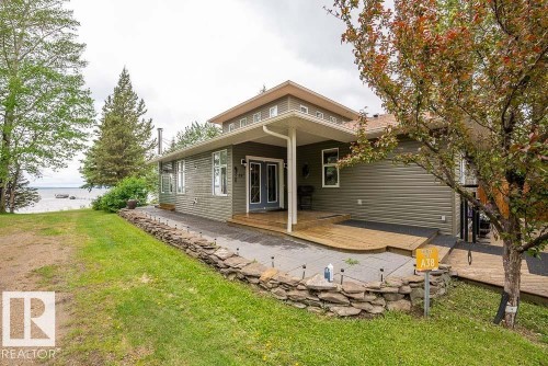 Waterfront property with a gray siding exterior featuring multiple windows - A38 Bernice Ave, Rural Leduc County, AB 