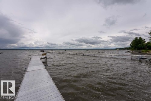 Waterfront setting featuring a private dock extending into the lake - A38 Bernice Ave, Rural Leduc County, AB 