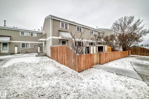 Townhome exterior featuring horizontal siding and multiple windows - 9D Castle Terrace, Edmonton, AB 