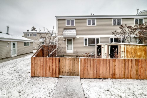 Two-story townhouse exterior with horizontal siding and multiple windows - 9D Castle Terrace, Edmonton, AB 
