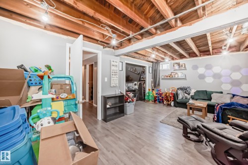 Finished lower level featuring exposed wood beam ceiling, recessed lighting, wood-finish flooring, and painted drywall - 5106 19 Avenue, Edmonton, AB 