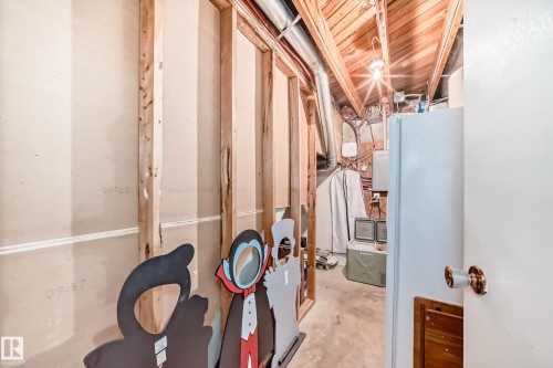Unfinished basement area with exposed wood framing, concrete flooring, and visible ceiling joists - 5106 19 Avenue, Edmonton, AB 