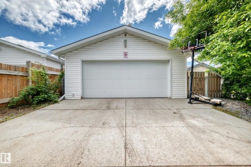 Detached garage featuring white vinyl siding and a white garage door - 5106 19 Avenue, Edmonton, AB 