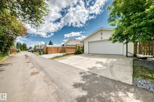 Detached garage with white siding and a wide driveway - 5106 19 Avenue, Edmonton, AB 