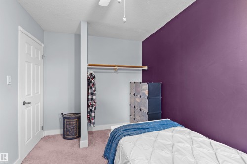 Room featuring light gray and deep purple walls - 12128 25 Avenue, Edmonton, AB - Indoor Photo Showing Bedroom