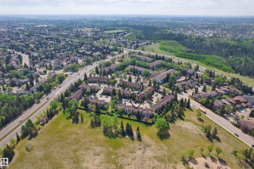 Aerial perspective showcasing a residential community with abundant mature trees and verdant landscapes - 12128 25 Avenue, Edmonton, AB - Outdoor With View