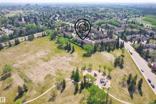 Aerial perspective showcasing a residential community with abundant green spaces - 12128 25 Avenue, Edmonton, AB - Outdoor With View