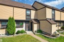 Exterior townhouse featuring a brown shingle roof, tan horizontal siding, and stucco finishes - 12128 25 Avenue, Edmonton, AB  - Outdoor 