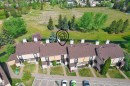 Row of townhomes featuring brown shingle roofing and light-colored siding - 12128 25 Avenue, Edmonton, AB  - Outdoor With View 