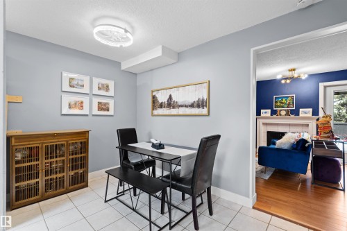 Dining area featuring light gray walls and white tile flooring - 12128 25 Avenue, Edmonton, AB - Indoor Photo Showing Dining Room