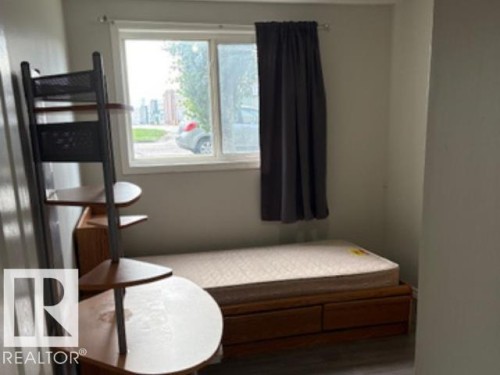 Room featuring a double-pane window with dark gray drapes - 107 10023 164St, Edmonton, AB 