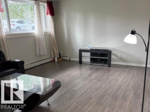 Gray wood-finish flooring complements light gray walls throughout the space - 107 10023 164St, Edmonton, AB 