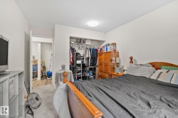 Bedroom featuring light gray carpeting, neutral wall paint, and a white ceiling with flush-mount lighting - 