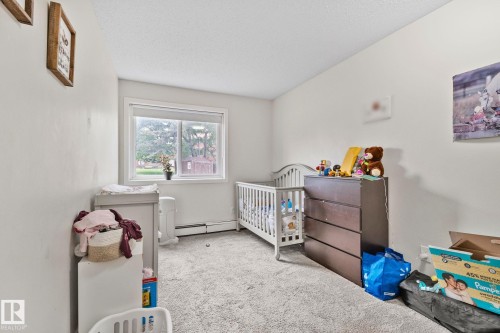 Spacious room with light-colored walls and soft carpeting - 115 4608 52 Avenue, Stony Plain, AB 