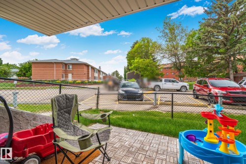 Outdoor patio featuring wood-look tile flooring and a partial overhead awning - 115 4608 52 Avenue, Stony Plain, AB 