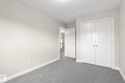 Room featuring light grey carpeting, neutral-toned walls, and white baseboards - 