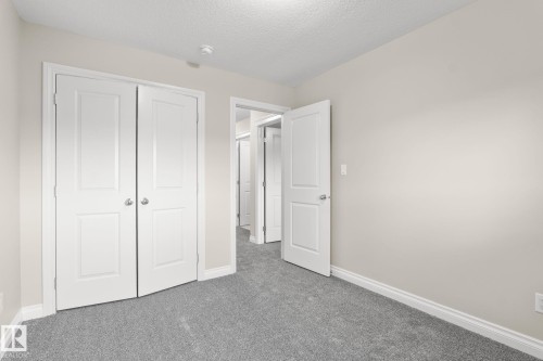 Room featuring light gray carpet, neutral wall paint, and white trim - 6927 Cardinal Wynd, Edmonton, AB 