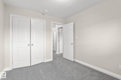 Room featuring light gray carpet, neutral wall paint, and white trim - 
