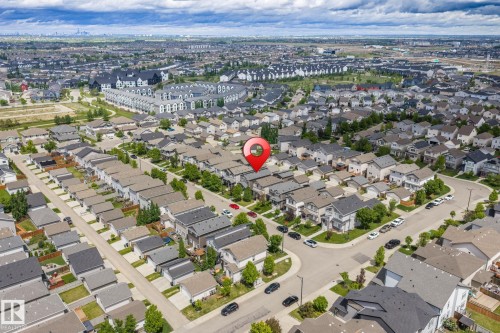 Residential neighborhood featuring a grid of detached homes with varied architectural styles and dark-pitched roofs - 6927 Cardinal Wynd, Edmonton, AB 