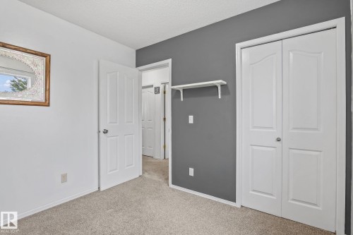 Interior room featuring neutral carpeting and white baseboards - 128 Brookview Wy, Stony Plain, AB 