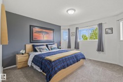 Bedroom featuring light gray carpeting, a textured ceiling, and a flush-mount ceiling light - 