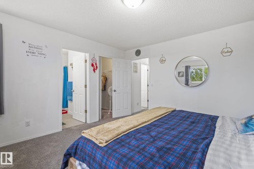 Bedroom featuring carpet flooring, white walls, and a ceiling-mounted light fixture - 128 Brookview Wy, Stony Plain, AB 