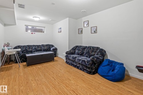 Finished lower level featuring light wood-finish flooring - 128 Brookview Wy, Stony Plain, AB 