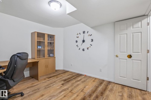 Spacious interior with wood-finish flooring, white walls, and a recessed ceiling light - 128 Brookview Wy, Stony Plain, AB 