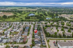 Aerial perspective showcasing a residential neighborhood with tree-lined streets and established homes - 