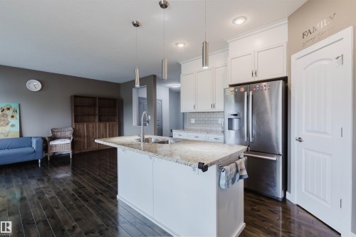 Open-concept kitchen and living area featuring dark wood-finish flooring - 21223 58 Avenue, Edmonton, AB 