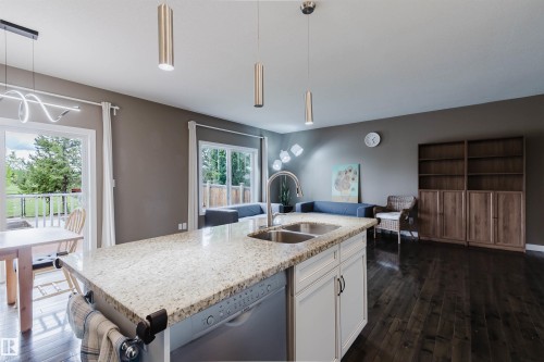 Kitchen island with granite countertop and double stainless steel sink - 21223 58 Avenue, Edmonton, AB 