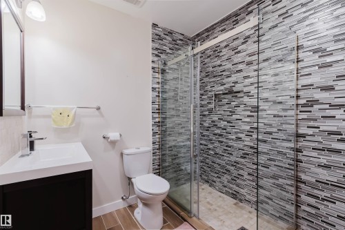 Glass-enclosed shower with horizontal mosaic tile surround - 21223 58 Avenue, Edmonton, AB 
