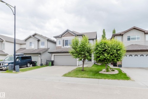 Two-story residence featuring a gray exterior with contrasting brown siding accents - 21223 58 Avenue, Edmonton, AB 