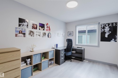 Recessed lighting illuminates this room featuring light wood-finish flooring, a white window frame, and neutral wall tones - 21223 58 Avenue, Edmonton, AB 