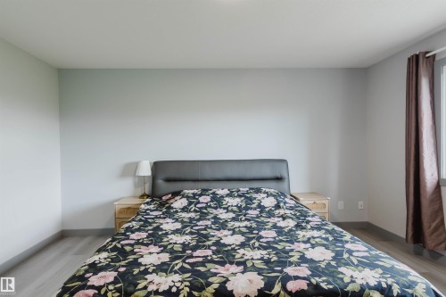 Light gray wall color, wood-finish flooring, and white baseboards - 21223 58 Avenue, Edmonton, AB 