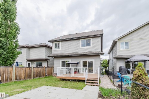 Rear exterior of a two-story residence featuring light gray siding - 21223 58 Avenue, Edmonton, AB 