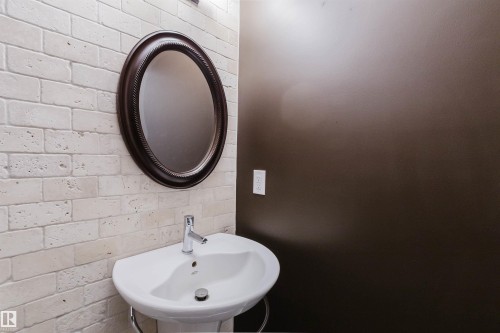 Pedestal sink featuring a chrome faucet - 21223 58 Avenue, Edmonton, AB 