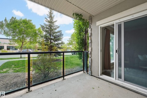 Outdoor balcony featuring a concrete surface, glass and metal railing, and a sliding glass door entry - 115 1238 Windermere Way, Edmonton, AB 