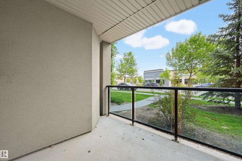 Private balcony featuring concrete flooring, stucco wall, and a glass and metal railing system - 115 1238 Windermere Way, Edmonton, AB 
