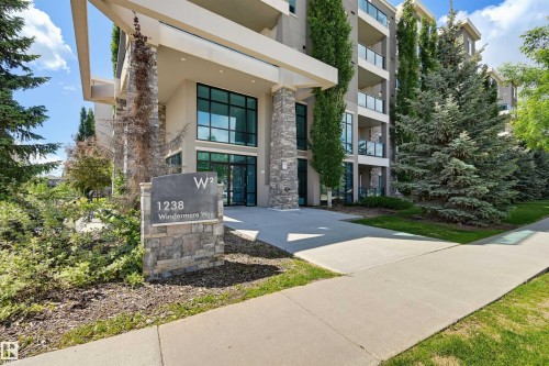 Modern multi-story building featuring a stone and stucco facade - 115 1238 Windermere Way, Edmonton, AB 